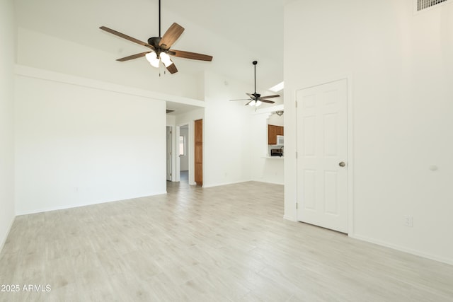 64 N 63rd St N Unit 33, Mesa, AZ 85205 - unfurnished living room with a ceiling fan, high vaulted ceiling, and light wood-style flooring