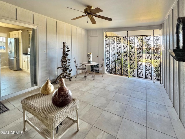 sitting room with ceiling fan and light tile patterned floors