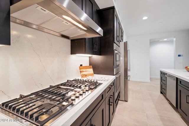 kitchen featuring appliances with stainless steel finishes and wall chimney range hood