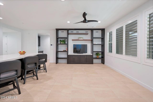 tiled living room featuring ceiling fan