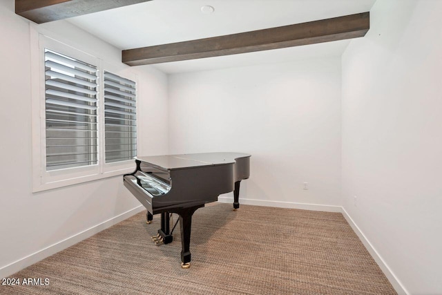 misc room featuring beamed ceiling and light colored carpet