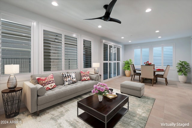 living room featuring ceiling fan and light tile patterned floors