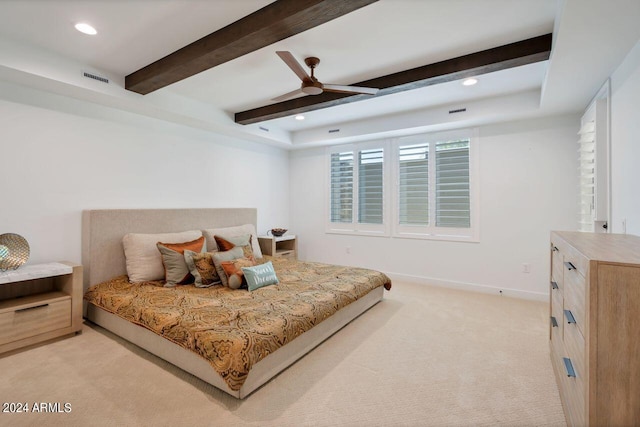 carpeted bedroom featuring ceiling fan and beamed ceiling