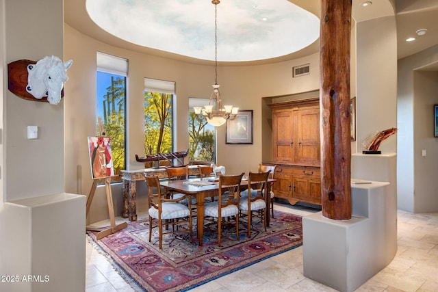 dining space with visible vents and a chandelier