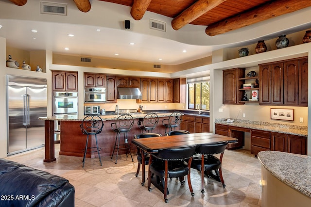 kitchen featuring under cabinet range hood, visible vents, appliances with stainless steel finishes, and open shelves