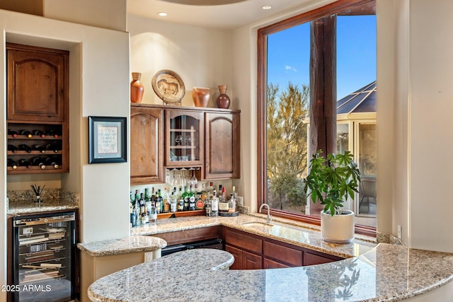 bar with beverage cooler, recessed lighting, a sink, and wet bar