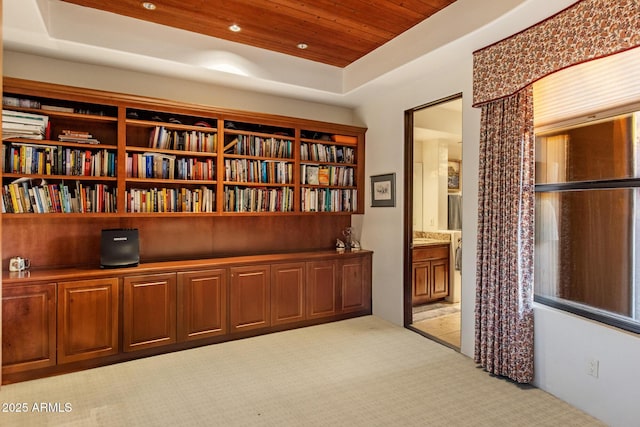 interior space featuring recessed lighting, a raised ceiling, wood ceiling, and light colored carpet