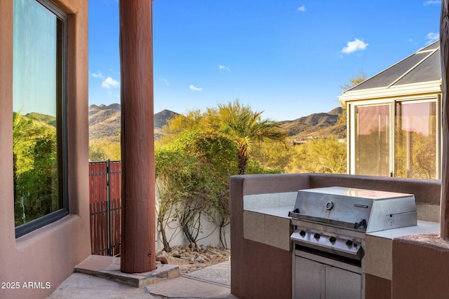 view of patio featuring grilling area, area for grilling, and a mountain view