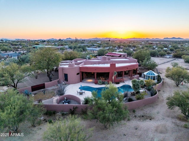 aerial view at dusk featuring a mountain view