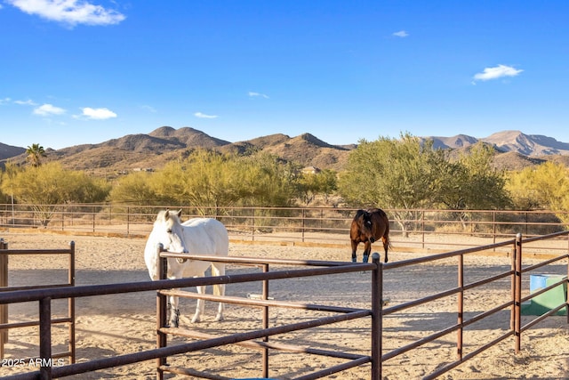 view of stable with a rural view and a mountain view