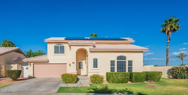 15211 N 89th Ave, Peoria, AZ 85381 - mediterranean / spanish home with a tiled roof, concrete driveway, stucco siding, solar panels, and an attached garage