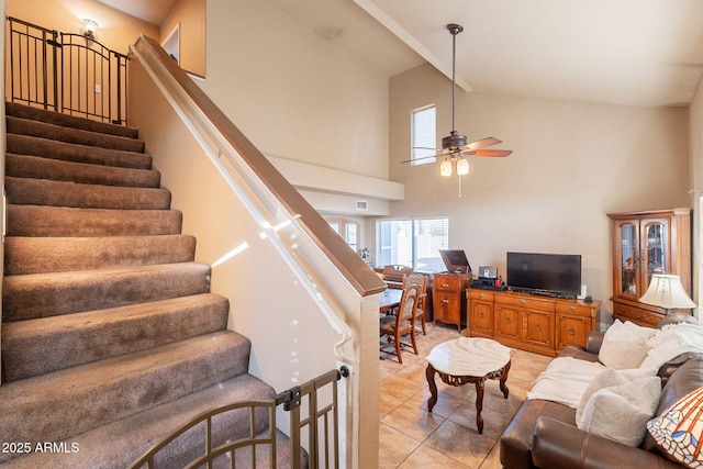 15211 N 89th Ave, Peoria, AZ 85381 - living area featuring light tile patterned floors, high vaulted ceiling, a ceiling fan, and stairs