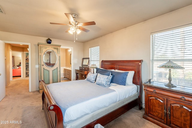 15211 N 89th Ave, Peoria, AZ 85381 - bedroom featuring light colored carpet, multiple windows, ensuite bath, and a ceiling fan