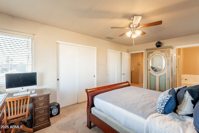 15211 N 89th Ave, Peoria, AZ 85381 - bedroom with light colored carpet, two closets, and a ceiling fan