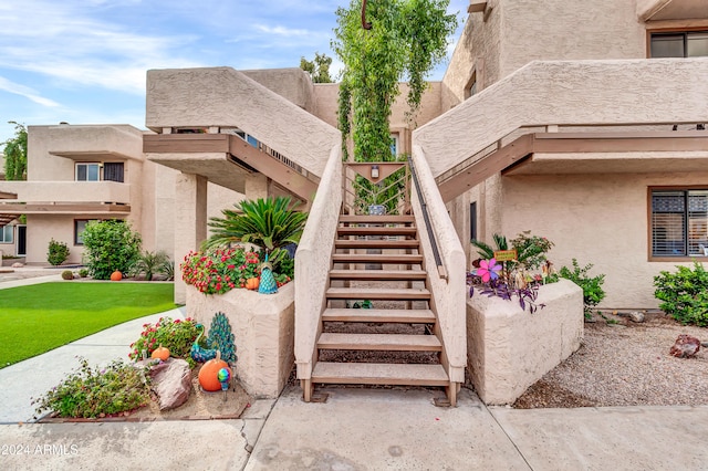 view of exterior entry featuring a yard