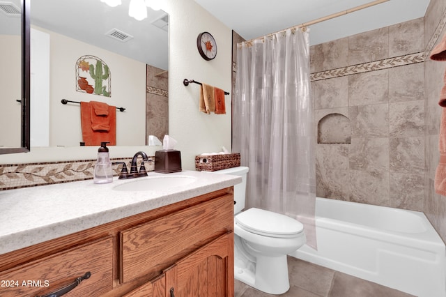 full bathroom with tile patterned floors, shower / tub combo with curtain, vanity, and toilet