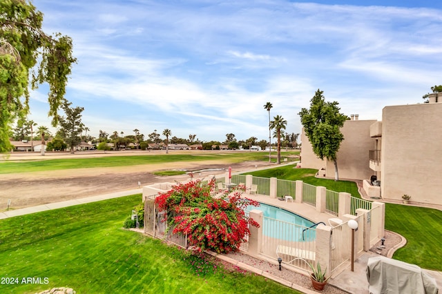 view of swimming pool featuring a lawn and a patio