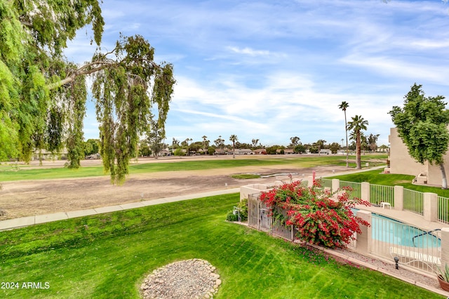 view of home's community with a yard and a swimming pool