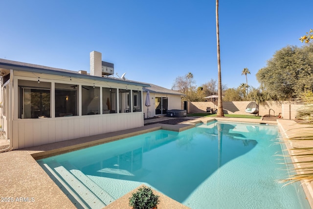 view of swimming pool with a sunroom