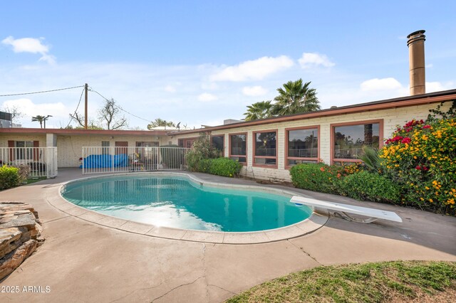 4461 E Flower St, Phoenix, AZ 85018 - outdoor pool featuring a diving board, a patio, and fence