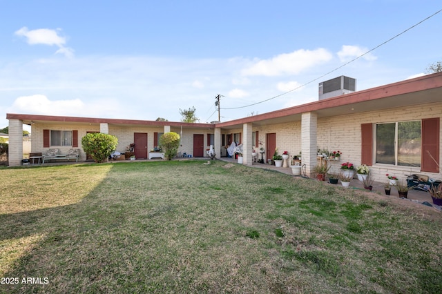 4461 E Flower St, Phoenix, AZ 85018 - rear view of property with brick siding and a lawn