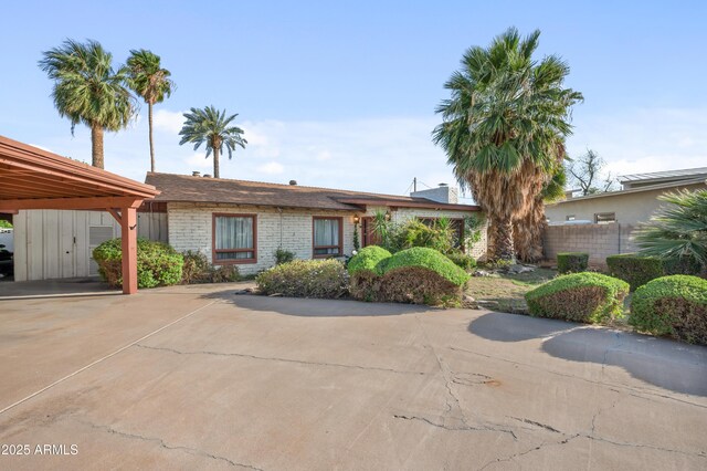 4461 E Flower St, Phoenix, AZ 85018 - view of front of house featuring brick siding and fence