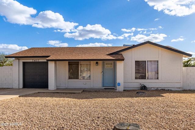 single story home featuring an attached garage, driveway, fence, and roof with shingles