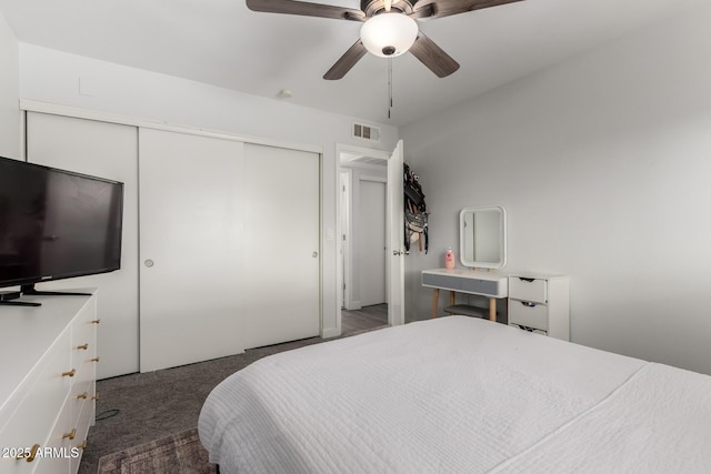 bedroom featuring a closet, carpet, visible vents, and a ceiling fan