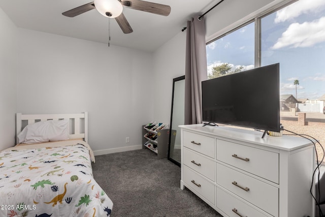 bedroom featuring ceiling fan, dark carpet, and baseboards