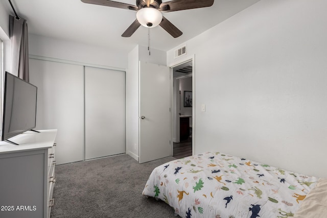 carpeted bedroom with ceiling fan, a closet, and visible vents