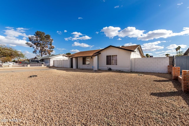 single story home with fence