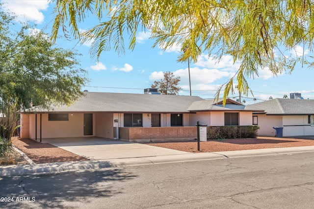 ranch-style home featuring a carport