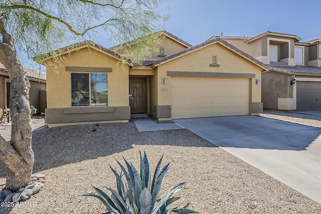 view of front facade featuring a tile roof, driveway, an attached garage, and stucco siding