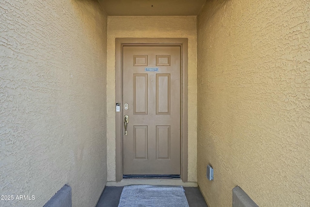 property entrance with stucco siding