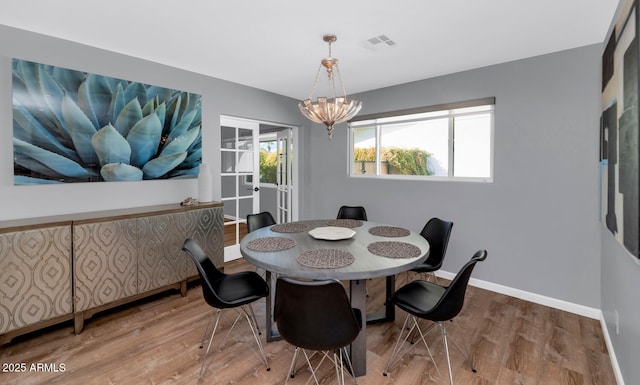 dining room featuring an inviting chandelier and hardwood / wood-style flooring