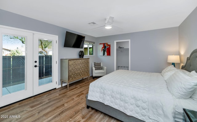 bedroom featuring ceiling fan, access to outside, french doors, and wood-type flooring