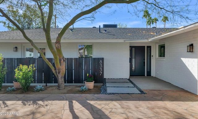 view of exterior entry with a patio