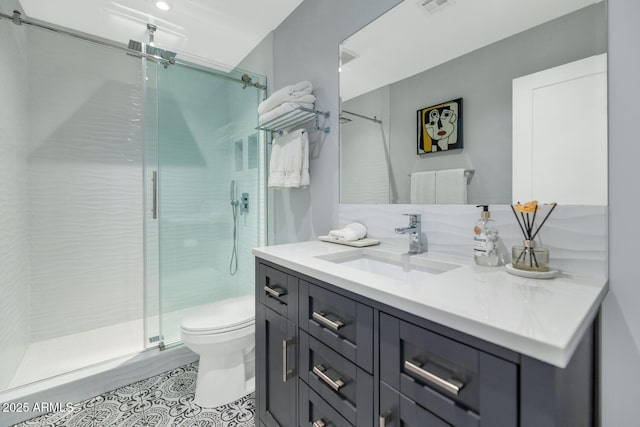 bathroom featuring vanity, toilet, and an enclosed shower