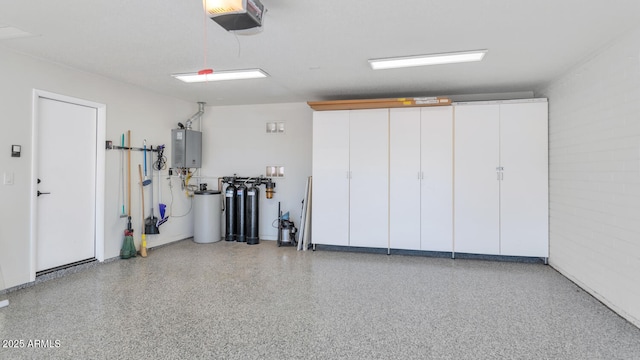 garage with a garage door opener and water heater