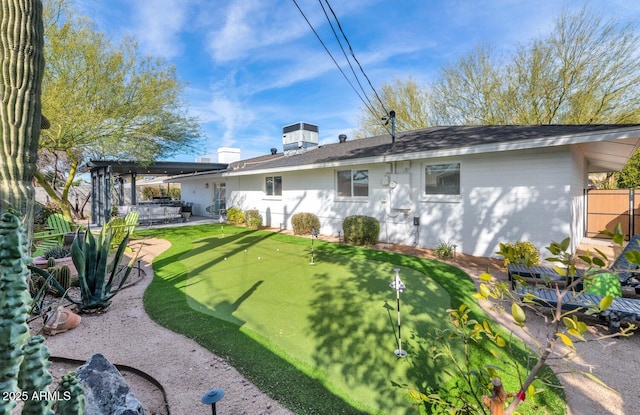 rear view of property with a patio, central AC, and a pergola