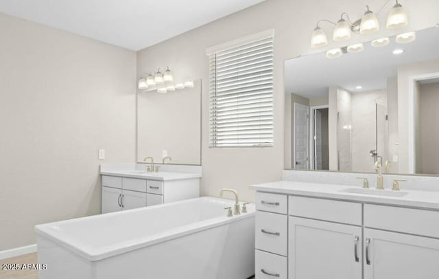 full bathroom featuring a freestanding bath, two vanities, a sink, and a shower stall