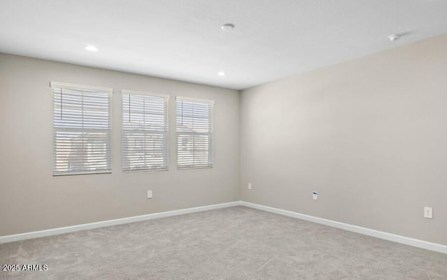 unfurnished room featuring baseboards, recessed lighting, and light colored carpet