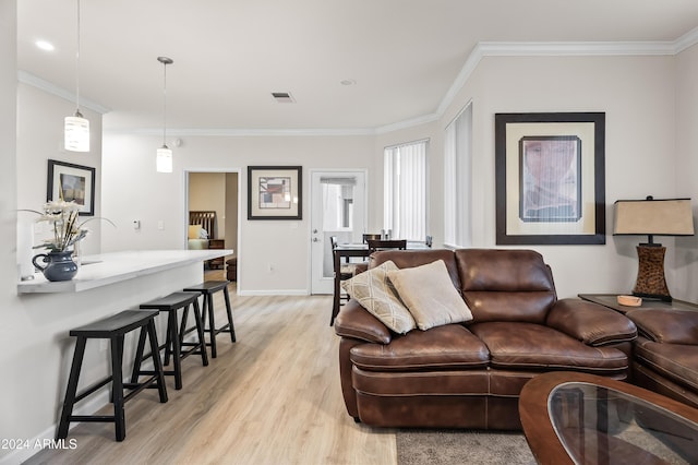 living room with light hardwood / wood-style floors and ornamental molding