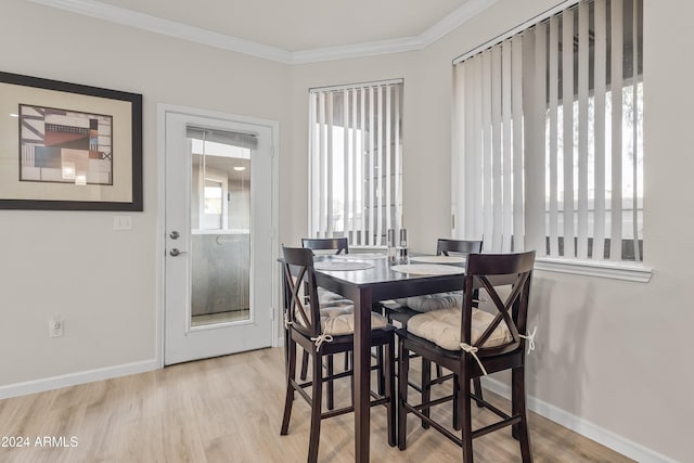 dining room featuring crown molding and light wood-type flooring