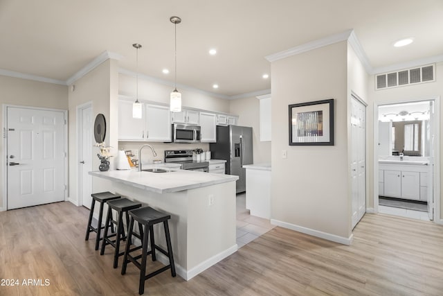 kitchen with kitchen peninsula, appliances with stainless steel finishes, sink, light hardwood / wood-style flooring, and white cabinetry