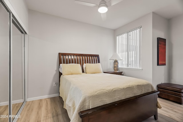 bedroom featuring ceiling fan, a closet, and light wood-type flooring