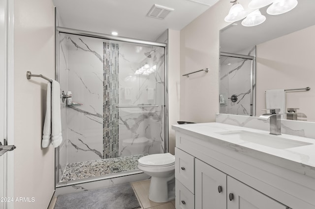 bathroom featuring toilet, vanity, and walk in shower