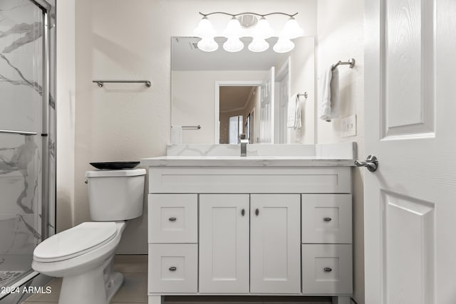 bathroom with vanity, an enclosed shower, and toilet