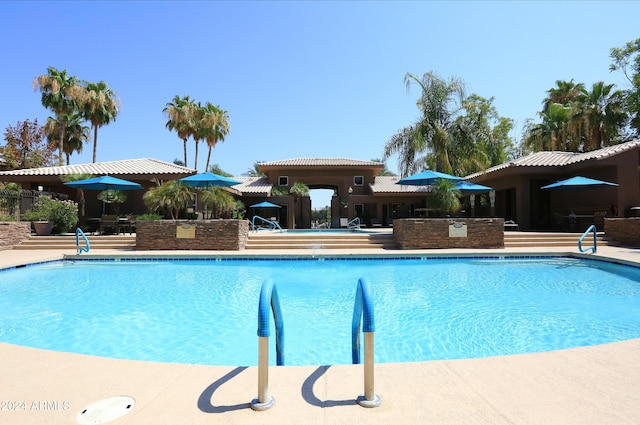 view of swimming pool with a patio area