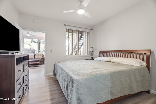 bedroom featuring light hardwood / wood-style flooring, multiple windows, and ceiling fan